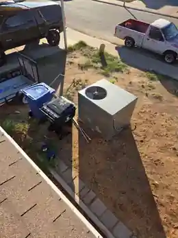 Rooftop package AC lowered to the ground during HVAC detach for a ProWest Roofing project